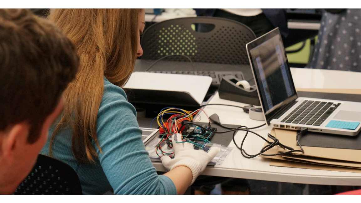 A student testing sensors through an interactive glove